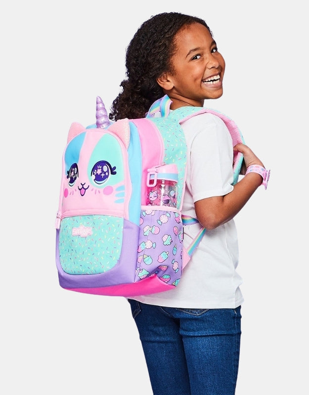 Girl wearing the Smiggle Best Classic Pink Backpack, smiling and showing the backpack's colorful design and unicorn horn.